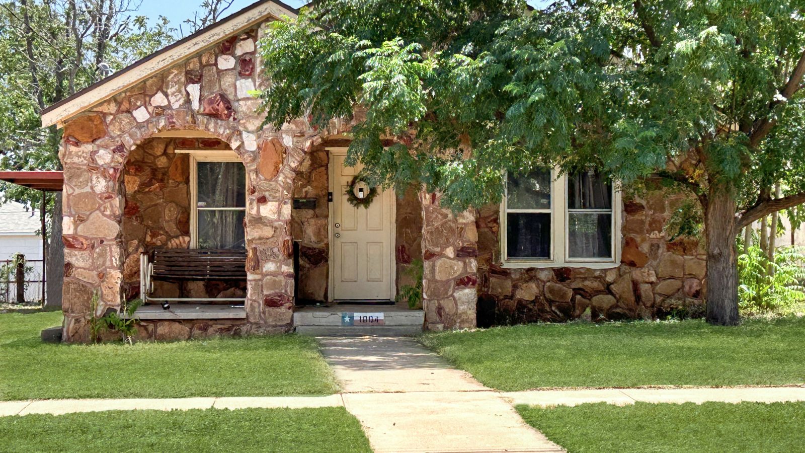 Red brick house, large entry way, large oak tree in the front yard, big front yard