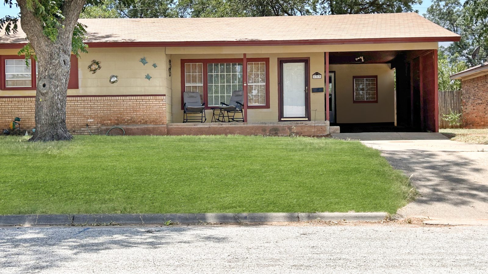 red brick on the lower half, white on the top half of the house, covered carport